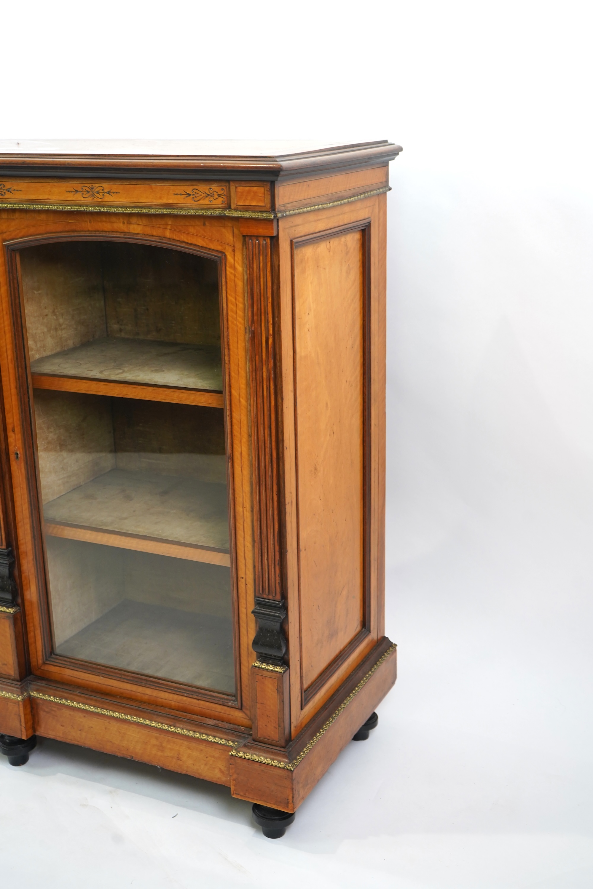 A Victorian marquetry inlaid and gilt metal mounted banded satinwood side cabinet, with anthemion carved frieze over a central door applied octagonal Wedgwood style green and white octagonal jasper plaque, flanked by gla